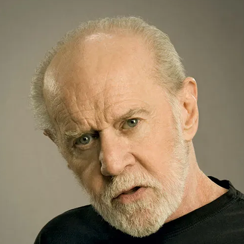 A light-skinned balding man with short gray hair, mustache, and beard